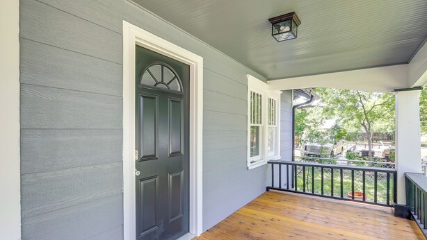 A porch with a dark door, white trim, and a wooden floor. - 4 Mi to Dtwn: Charming Retreat in Wichita! (Wichita)