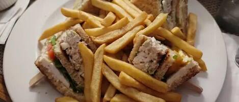 A plate with a sandwich and french fries.