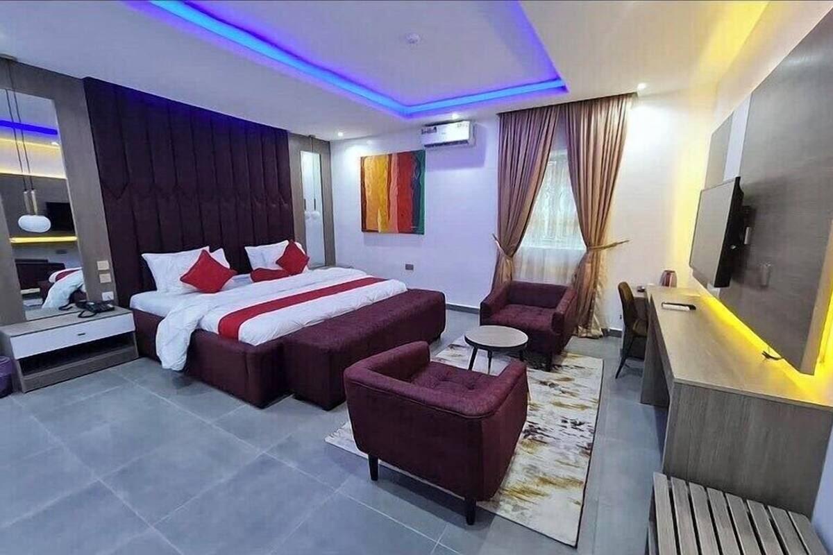 Ein modernes Hotelzimmer mit einem großen Bett, einem Schreibtisch und einer Sitzecke.