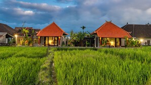 A traditional building with a red roof, surrounded by lush green rice fields. - Seelong Villa Ubud by Dhananjaya Hospitality (Sebatu)
