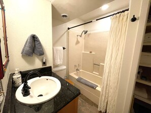 Shower, hair dryer, towels, shampoo