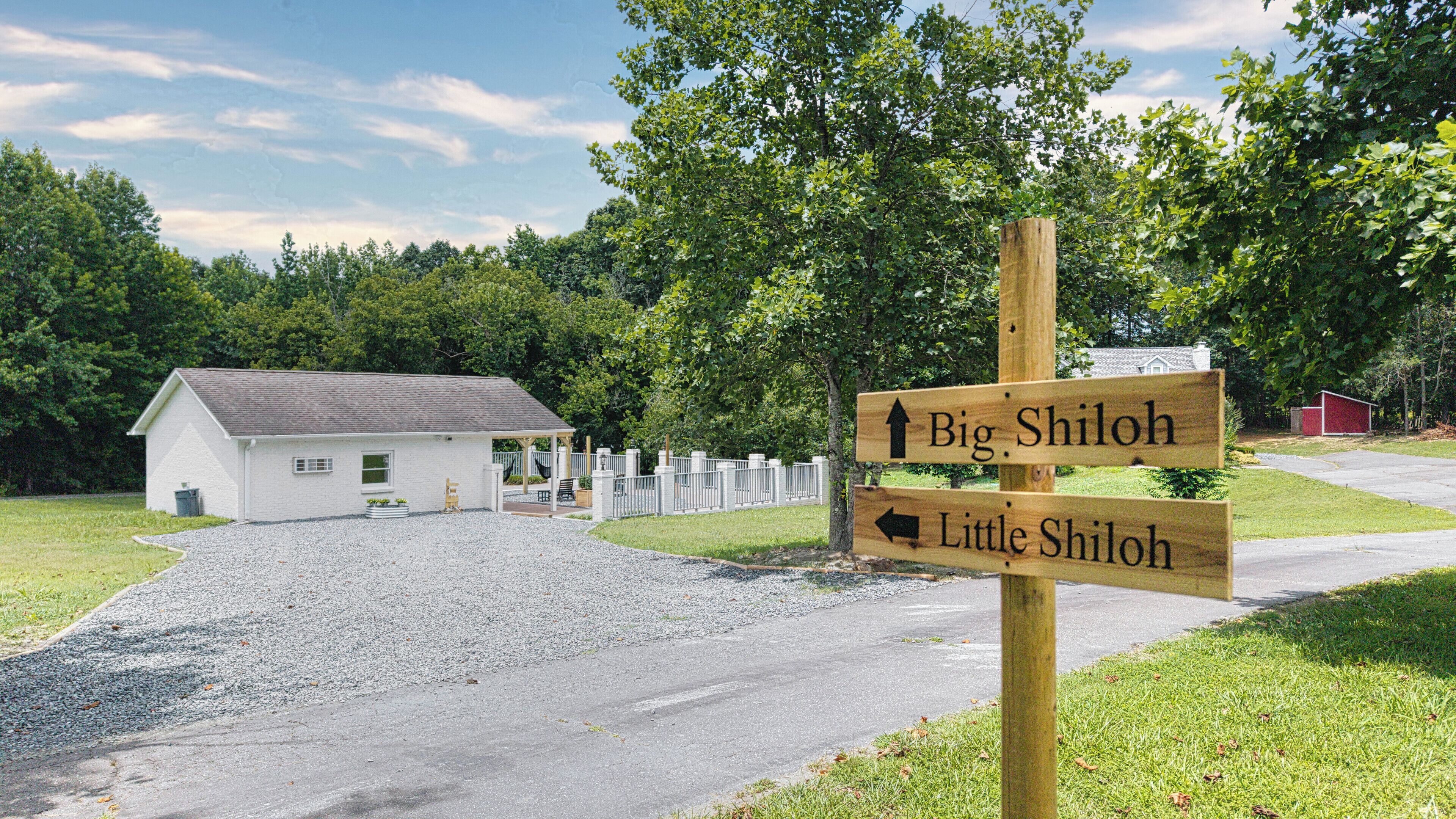 A wooden signpost with directions to Big Shiloh and Little Shiloh.