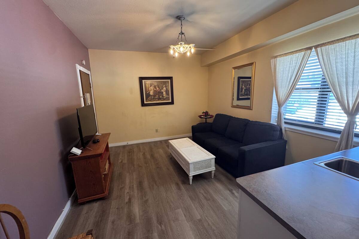 Family Suite, 1 King Bed with Sofa bed, Non Smoking, Kitchenette | Living room | 35-inch Smart TV with cable channels