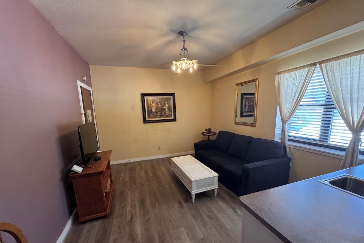 Family Suite, 1 King Bed with Sofa bed, Non Smoking, Kitchenette | Living room | 35-inch Smart TV with cable channels