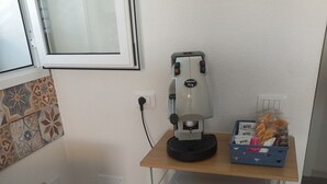 A kitchen with a coffee machine, a microwave, and a small cart with items on it. - Holiday Home 'Casa Damari-Beachfront' with Sea View and Private Terrace (Petrosino)
