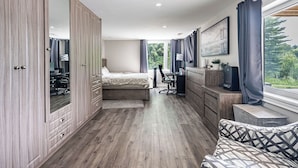 A bedroom with a bed, desk, and wardrobe. - 5-Bedroom Countryside Estate in Northern GTA – Ideal for Gatherings & Getaways (Bolton)