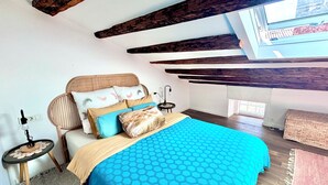 A bedroom with a bed, a bedside table, a lamp, a window, and a view of the outside. - Seagull's View - Breezy 1 Bedroom with Seaview in the Heart of Rovinj's Old Town (Rovinj)