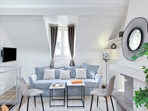 Deluxe Duplex, Courtyard View | Living area | 80-cm Smart TV with digital channels