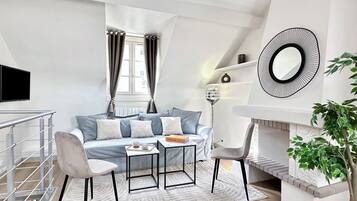 Deluxe Duplex, Courtyard View | Living area | 80-cm Smart TV with digital channels