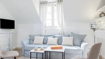 Deluxe Duplex, Courtyard View | Living area | 80-cm Smart TV with digital channels