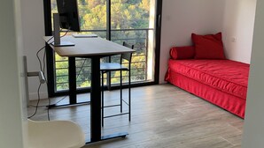 A room with a desk, computer, and a red bed. - Nice 4-Bedroom California-Style Villa (Nice)