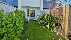 A modern two-story house with a well-maintained lawn and a wooden fence. - Homey and Bright Riccarton 1BR (Christchurch)