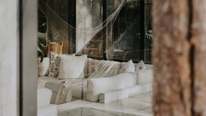 A modern living room with a white sofa, patterned cushions, and a hammock. - 3-bedroom house in amazing Tulum with Private Pool (Tulum)