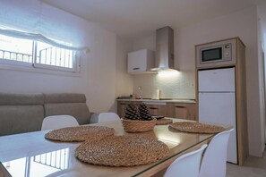 Fridge, microwave, stovetop, dining tables