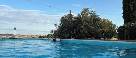 Seasonal outdoor pool, open 9:00 AM to 8:00 PM, pool umbrellas