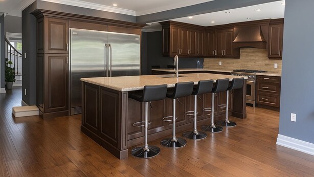A modern kitchen with dark wood cabinets, stainless steel appliances, and a central island with bar stools. - Luxury home 4BR, Pool, & 5 Mins to 401 (Whitby)