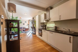 Fridge, dishwasher, coffee/tea maker, cookware/dishes/utensils