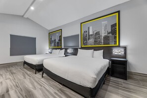 A modern hotel room with a large bed, two bedside tables, and three framed cityscape pictures on the wall. - Super 8 by Wyndham Texas City/Galveston Area (Texas City)