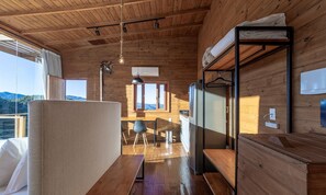 A wooden cabin interior with a dining area, a bunk bed, and a view of the mountains. - Chalet in Mountains With Magnificent Views Vst017 (Anitapolis)