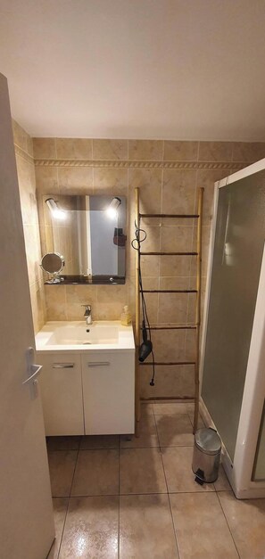 Ein Badezimmer mit Waschbecken, Spiegel und Waschtisch.