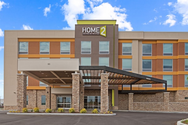 A modern hotel building with a 'HOME 2' sign, multiple windows, and a covered entrance area. - Home2 Suites By Hilton Lebanon (Lebanon)
