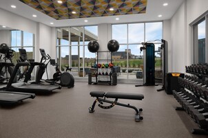 A gym with treadmills, a bench press, and weightlifting equipment.