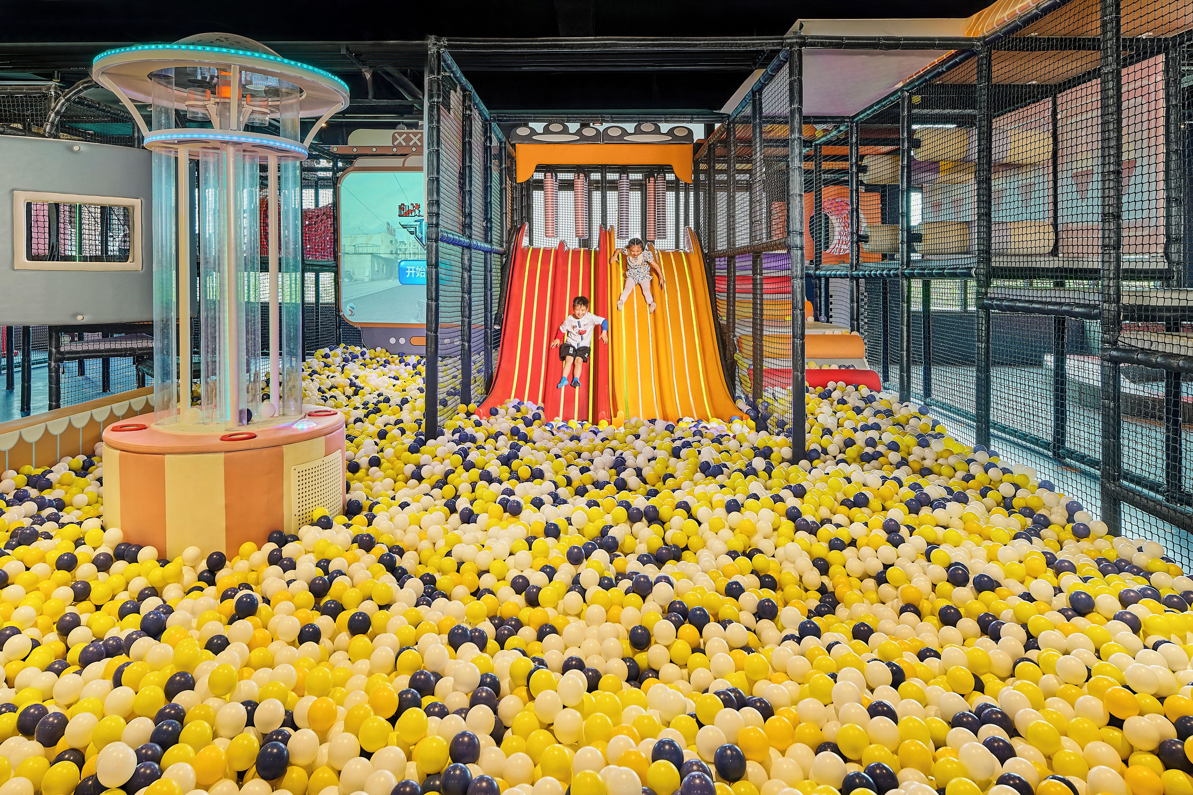 A play area with a ball pit, slides, and a climbing structure.