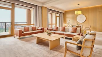 A spacious living room with a large sofa set, a coffee table, and a wooden chair.