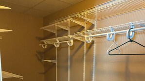 A laundry room with metal shelving, a fan, and a hanging rack. - Tundra Apt #2-Modern Comfort in the Last Frontier (For families or casual travelers) (Tok)