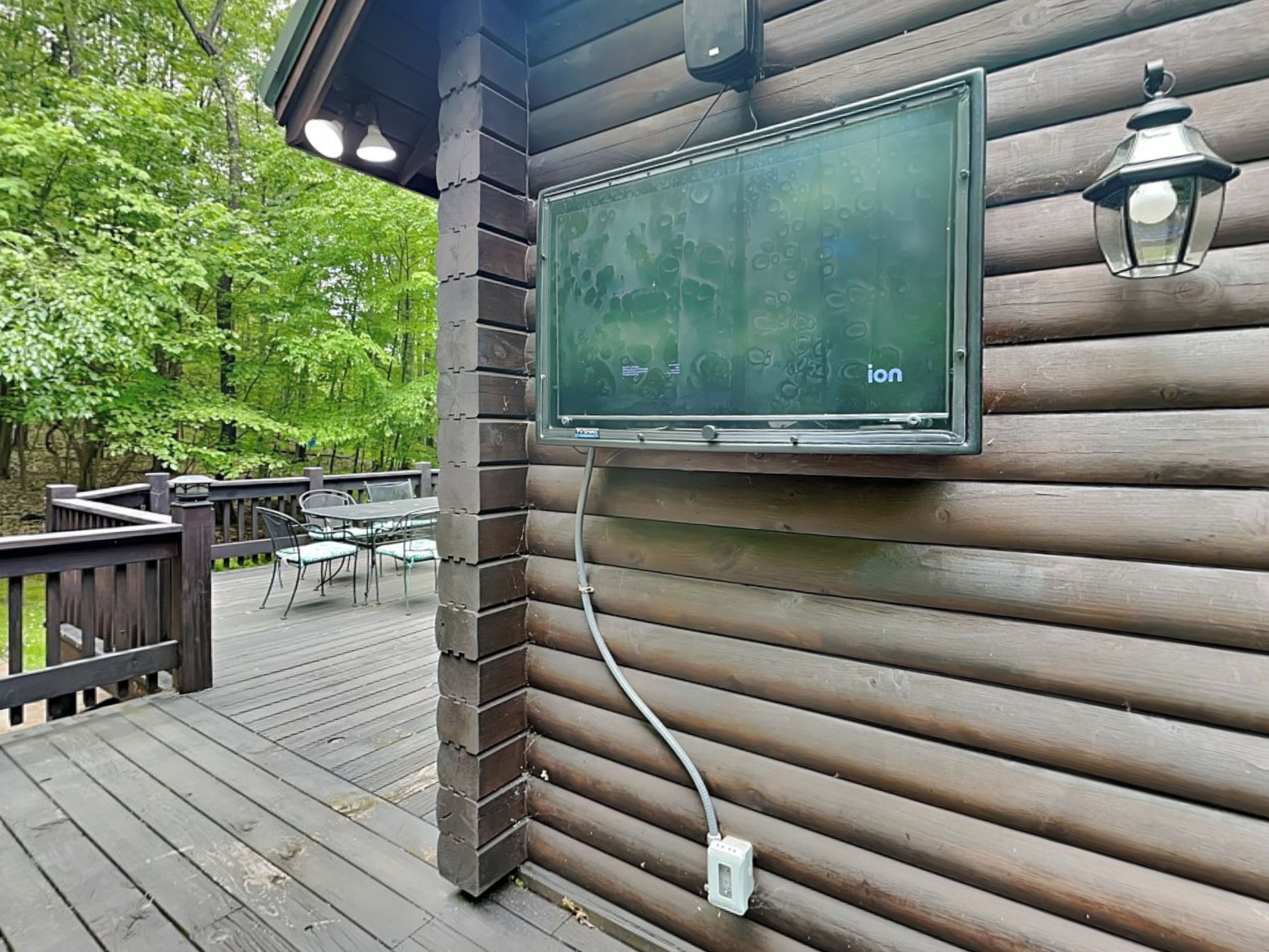 A wooden deck with a mounted television screen displaying the word "ion".