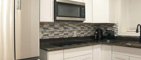 Fridge, microwave, stovetop, coffee/tea maker