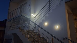 A building with a staircase, metal railings, and exterior lighting. - 100 meters from the blue flag awarded Mesi Beach. (Paralia Mesis)