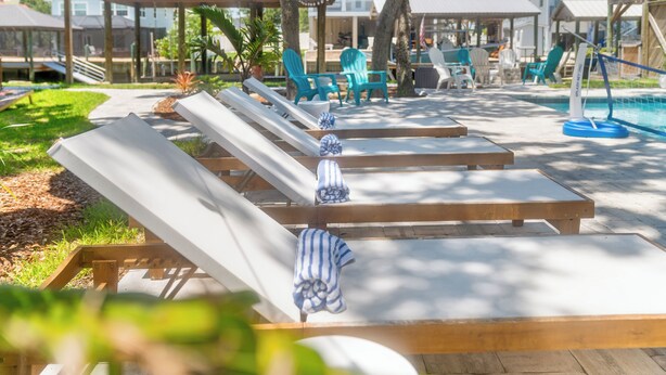 A poolside area with lounge chairs and a pool.