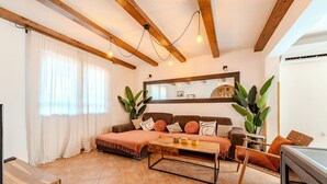 A cozy living room with a sofa, coffee table, and a large mirror. - Amazing home in Zagrad (Zagrad)