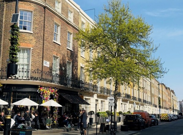 A row of terraced houses with a coffee house on the ground floor. - Ebury House (London)