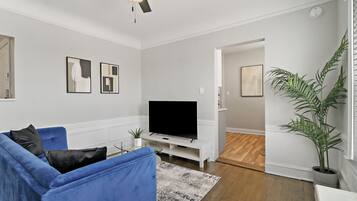 Deluxe Apartment, 2 Bedrooms | Living area | 55-inch TV with digital channels, streaming services