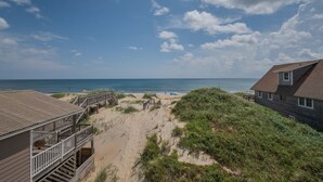 A beach house with a wooden deck and a view of the ocean. - 5770- What A View - Oceanfront Getaway Near Jennette's Pier (Nags Head)