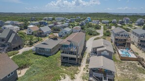 A coastal residential area with multiple two-story houses, some with balconies and a visible swimming pool. - 5770- What A View - Oceanfront Getaway Near Jennette's Pier (Nags Head)