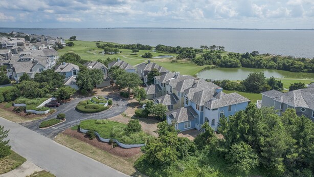 A residential area with houses, a golf course, and a lake. - 5593-Craven Haven, Nags Head OBX Retreat | Pool & Sunset Views (Nags Head)