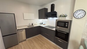 Una cocina moderna con lavavajillas, horno y microondas.