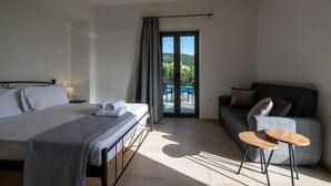 A modern hotel room with a bed, a sofa, a small table, and a balcony with a pool view. - House of Muses: Erato (Lefktro)