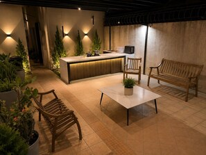 A modern interior with a reception desk, wooden furniture, and potted plants.