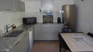A compact kitchen with a microwave, toaster, and coffee maker.