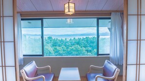 A room with a large window, two chairs, a small table, and a traditional Japanese shoji screen. - Inawashiro Kanko Hotel  (Inawashiro)