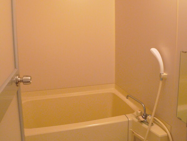 A bathroom with a bathtub, a shower, and a toilet.