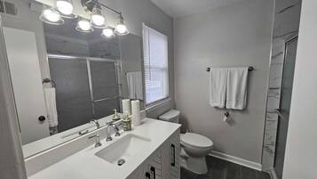 Shower, hair dryer, towels, toilet paper