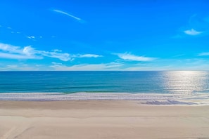 A beach with a clear sky and calm sea.