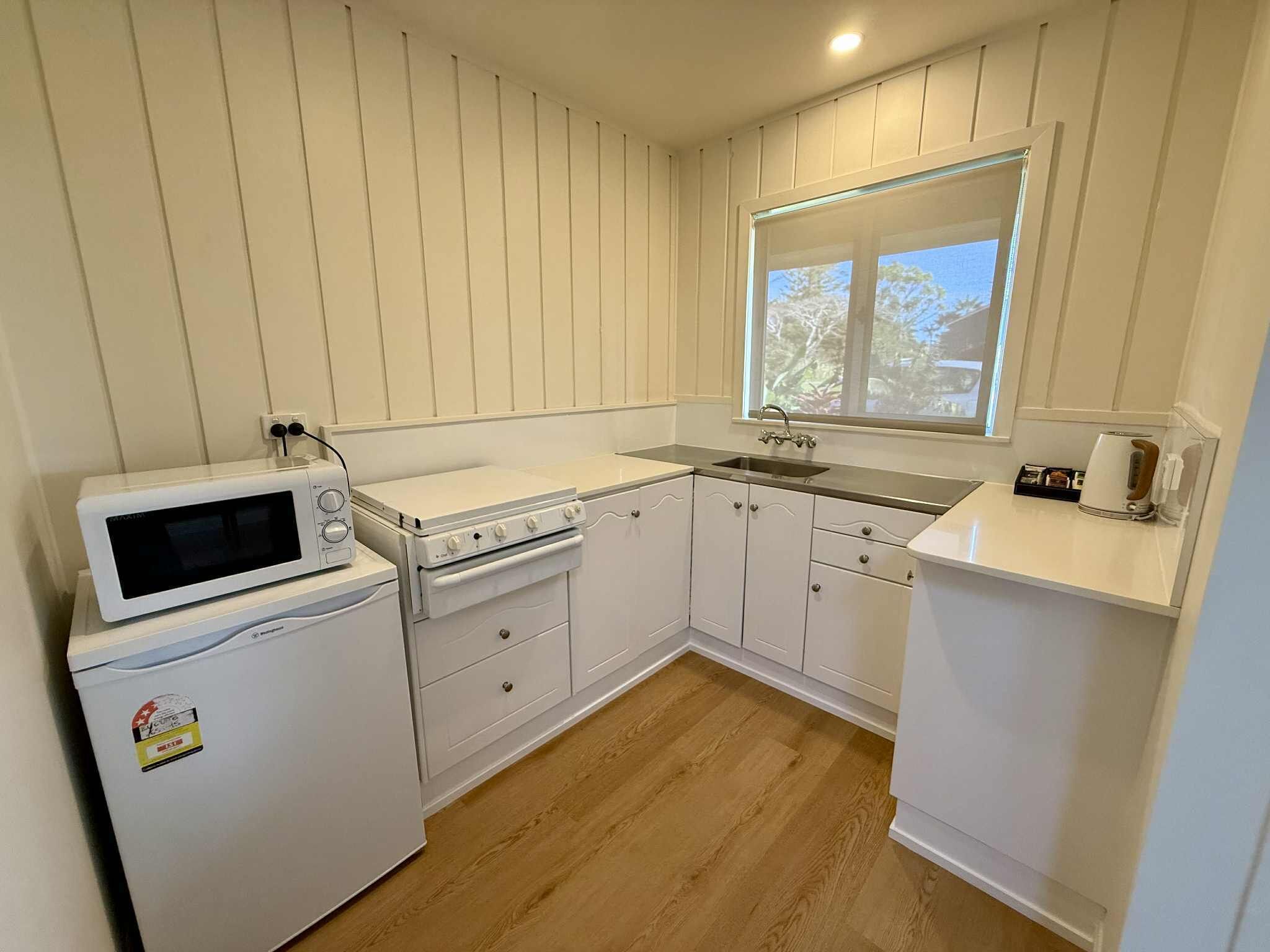 Full-sized fridge, microwave, cookware/dishes/utensils