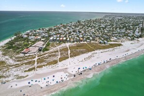 An aerial view of a coastal residential area with houses, a beach, and a marina. - McBean Point: Dog Friendly! Walk to Bean Point! by Anna Maria Life Vacation Rentals (Anna Maria)
