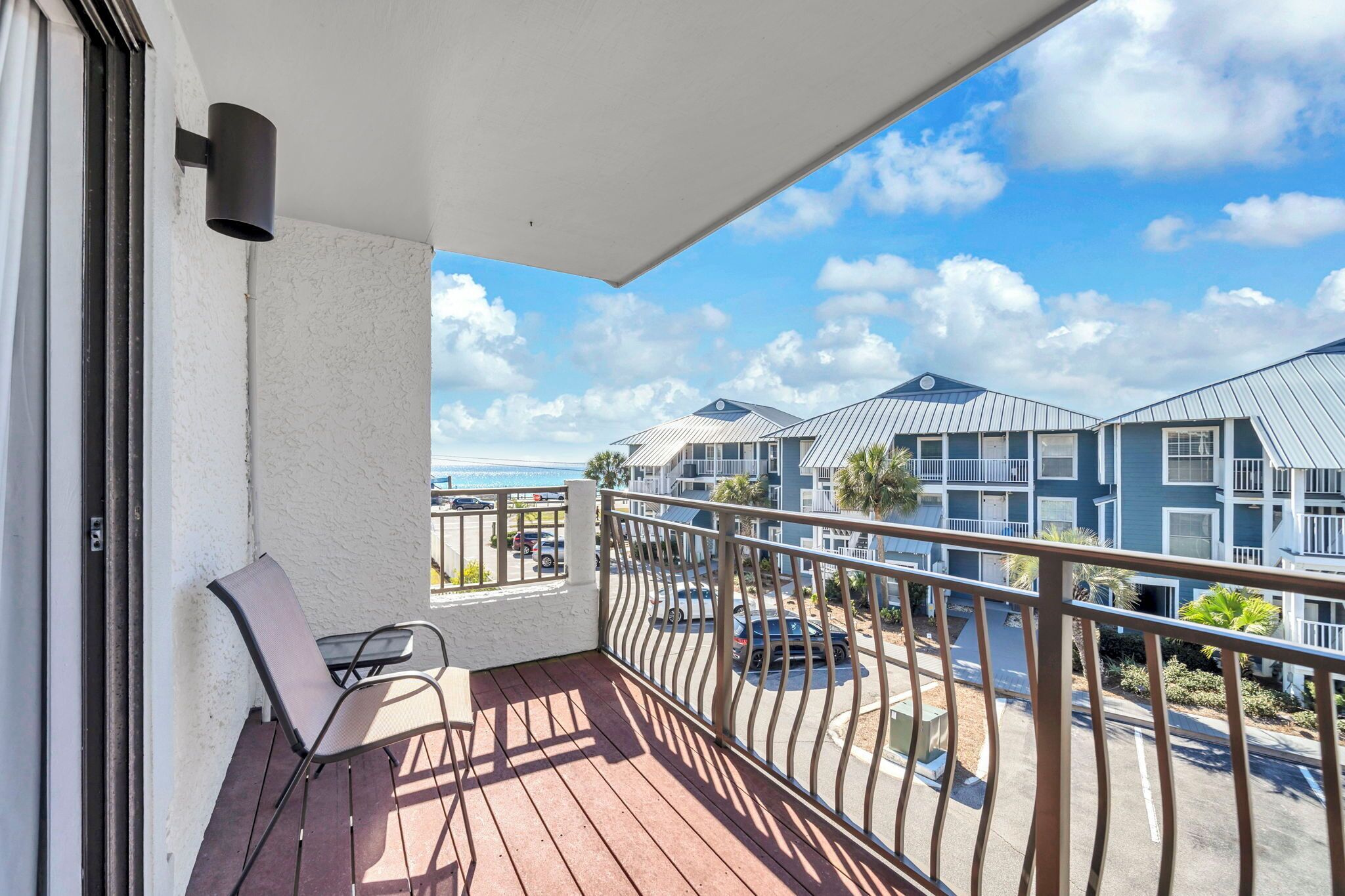 A balcony with a view of a coastal building complex.